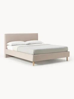 Cama tapizada con patas de madera Giulia