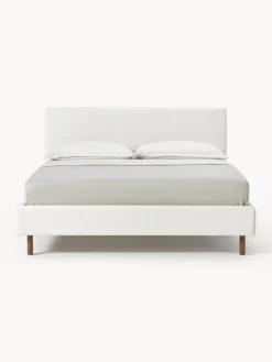 Cama tapizada con patas de madera Giulia