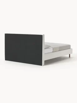 Cama tapizada con patas de madera Giulia