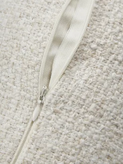 Cojín rulo en tejido bouclé con ribete Aya