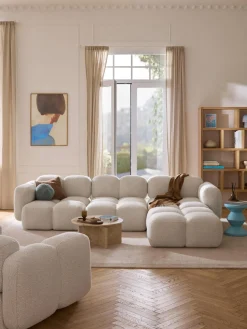 Sofá modular en tejido bouclé con reposapiés Tayla (4 plazas)